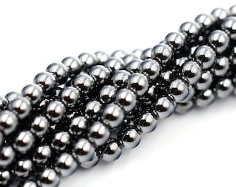 May include: A strand of black hematite beads, each bead is round and smooth with a high polish.