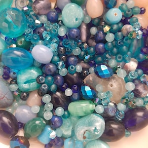 May include: A set of three ceramic mugs with a speckled, matte finish. The mugs are in shades of cream, light gray, and dark gray. Each mug has a simple, minimalist design and a rounded handle.