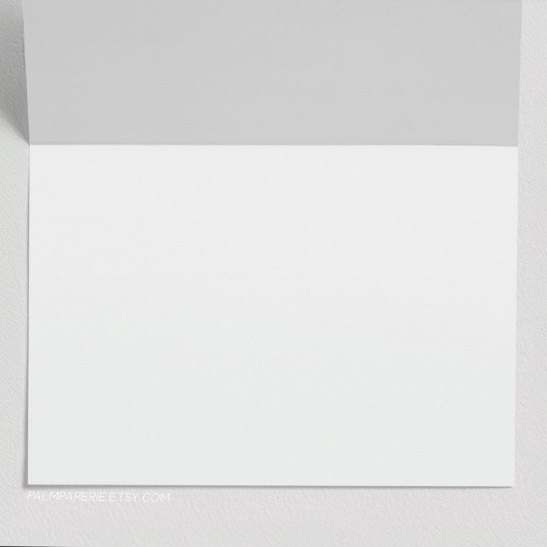May include: A blank white card with a gray border. The card is folded in half and has a website address printed on the bottom.