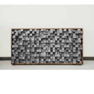 May include: A large gray wooden acoustic panel made of many small squares. The panel is framed in a dark wood frame.
