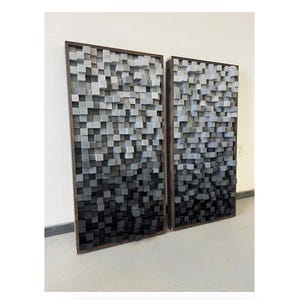 May include: Two large wall panels made of wood blocks in a gradient of gray and black. The panels are framed in dark wood and are arranged side by side.
