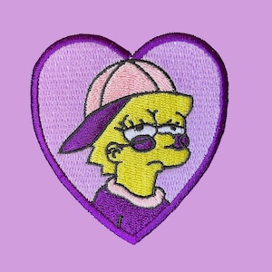 Puede incluir: Parche bordado en forma de corazón morado con un personaje de dibujos animados amarillo que lleva una gorra de béisbol rosa y gafas de sol. El personaje lleva una camisa morada y mira hacia la derecha.