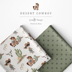 May include: Two folded fabric swatches. One features a white background with a repeating pattern of cartoon cowboys, horses, cacti, skulls, and lassos. The other is a solid sage green fabric with a repeating pattern of small dark green stars.