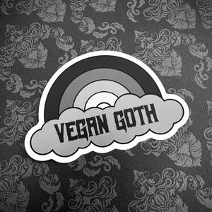 May include: Black and white sticker with a rainbow and a cloud that says "Vegan Goth".