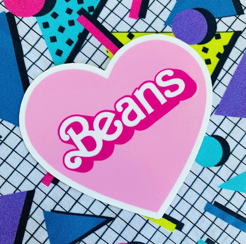 May include: A pink heart-shaped sticker with the word "Beans" in white letters with a pink outline. The sticker is on a background of colorful geometric shapes.