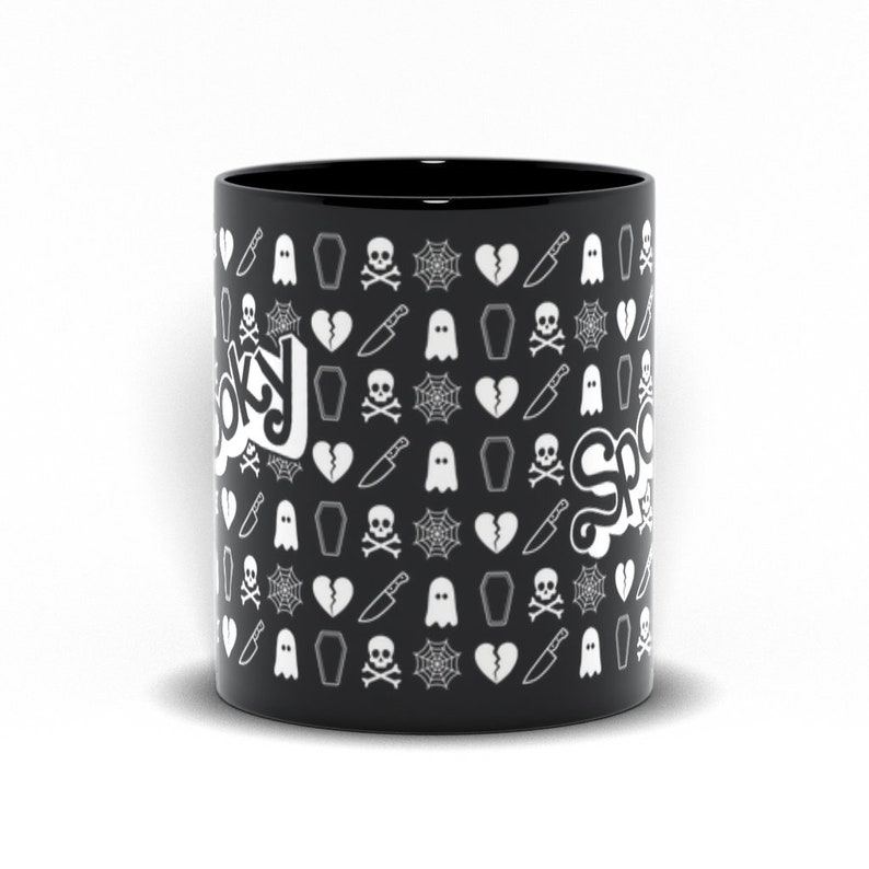May include: Black ceramic mug with a repeating pattern of white spooky-themed icons, including ghosts, coffins, spiderwebs, and broken hearts. The word "Spooky" is written in white script on the side of the mug.