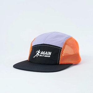May include: A running cap in black, purple, and orange, featuring the text "AGAIN DO IT AGAIN". The cap has a black peak, a purple crown, and orange mesh side panels. A white runner graphic is on the front.