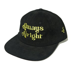 May include: Black corduroy baseball cap with a gold embroidered inscription that reads "Always Alright".
