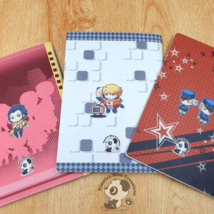 May include: Three different notebook covers with various designs. The first cover is pink with a white panda bear logo and a cartoon image of a group of people. The second cover is white with a gray and white checkered border and a cartoon image of a person in a space suit. The third cover is red with a black and white checkered border and a cartoon image of two people in police uniforms. All three covers have the text "Timelax Mini Creations" and a panda bear logo.