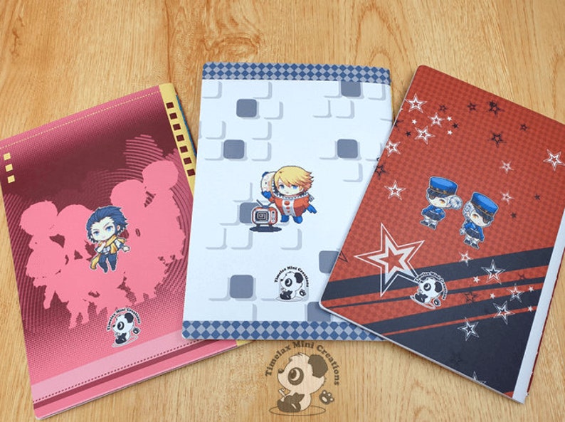 May include: Three different notebook covers with various designs. The first cover is pink with a white panda bear logo and a cartoon image of a group of people. The second cover is white with a gray and white checkered border and a cartoon image of a person in a space suit. The third cover is red with a black and white checkered border and a cartoon image of two people in police uniforms. All three covers have the text "Timelax Mini Creations" and a panda bear logo.