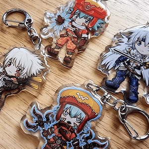 May include: A collection of acrylic keychains featuring anime-style characters. The keychains showcase various characters in vibrant colors, including red, orange, blue, and white. Each keychain has a silver metal ring for attachment.