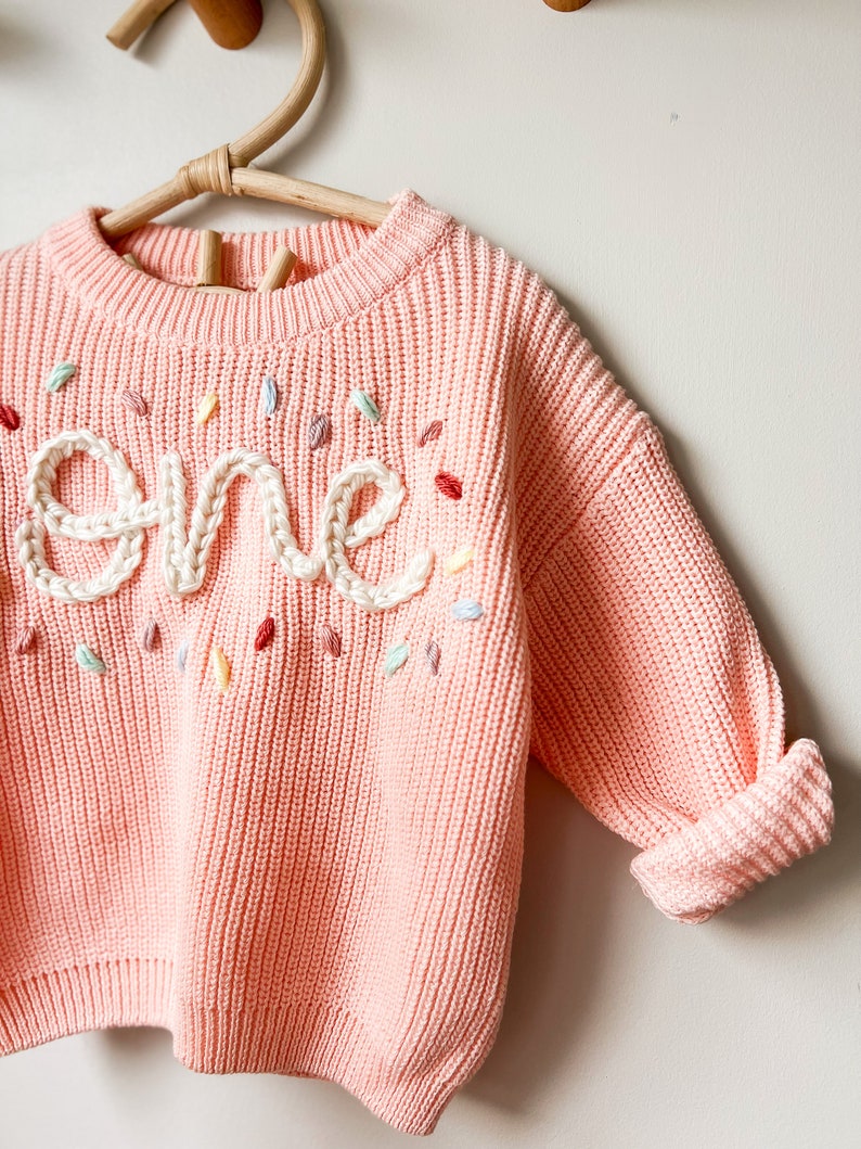 Bubblegum pink sweater, cream writing