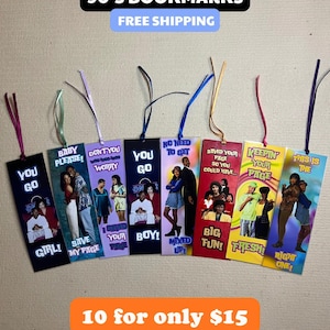 May include: A collection of colorful 90's-themed bookmarks. Each bookmark features images of people and phrases like "Baby Please!" and "You Go Girl!" with attached ribbons. The bookmarks are rectangular and have a variety of colors.