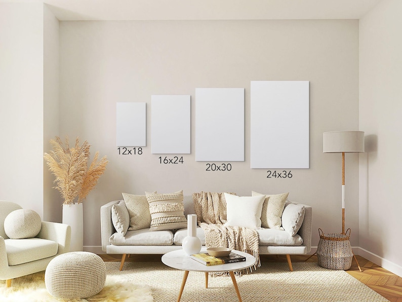 May include: Four blank white canvas prints in varying sizes: 12x18, 16x24, 20x30, and 24x36 inches, displayed on a wall above a sofa. The room has a neutral color palette with decorative elements.