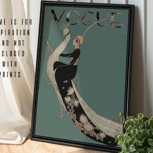 May include: A framed vintage Vogue magazine cover print. The artwork features a woman in a black dress riding a peacock against a teal background. The Vogue logo is at the top. Text on the left side reads "FRAME IS FOR INSPIRATION AND NOT INCLUDED WITH PRINTS."