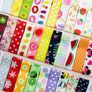 May include: Assortment of colorful patterned ribbon with various designs, including polka dots, stripes, floral, and cartoon characters. The ribbon is approximately 1 inch wide.
