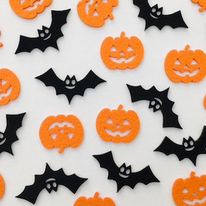 May include: A collection of orange felt jack-o'-lanterns and black felt bats scattered on a white surface. The pumpkins have carved-out faces, and the bats have smiling faces. The Halloween-themed decorations are ideal for crafts.