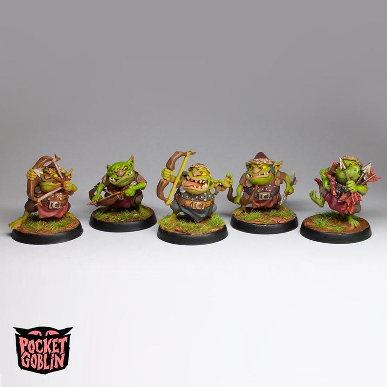 May include: Five miniature goblin figurines, each with unique details. They are painted in shades of green, brown, and red, and are posed with bows and arrows. The figurines are on circular bases with grass-like texture. The Pocket Goblin logo is at the bottom.