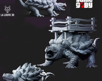 May include: Three gray, 3D-printed Ankylosaurus-like creatures. One has a wooden structure on its back. The creatures have textured shells and detailed features. The image includes the text "LA LOUVE 3D" and "game 9 BY".