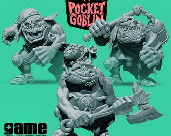 May include: Three gray goblin figurines in dynamic poses, each holding a weapon. The figures have exaggerated features and are set against a green background. The Pocket Goblin logo is visible above the figures, and the Game 97 By logo is at the bottom.