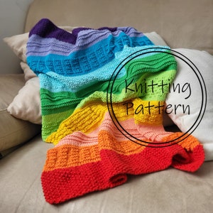 May include: A colorful knitted blanket with a rainbow gradient of colors, including red, orange, yellow, green, blue, and purple. The blanket has textured patterns and is draped over a couch. The text "Knitting Pattern" is in a circle on the blanket.