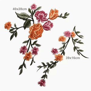 May include: Two embroidered floral patches with green stems and leaves. The larger patch is 40x28 cm and features orange, pink, and peach flowers. The smaller patch is 39x16 cm and features pink and orange flowers.