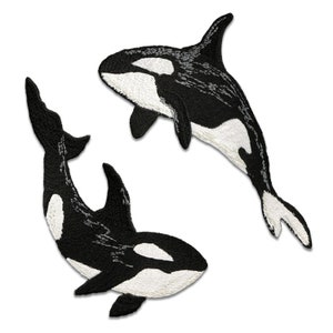 May include: Two black and white orca whale embroidered patches. The orcas are swimming in opposite directions.