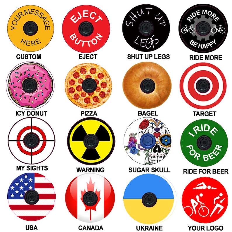 May include: A set of 16 colorful bike stem caps with various designs, including a donut, pizza, bagel, target, skull, warning sign, American flag, Canadian flag, Ukrainian flag, and a logo. The caps are round and have a hole in the center for the stem.