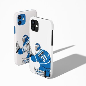 May include: White iPhone case with a blue and white hockey goalie illustration. The goalie is wearing a blue jersey with the number 31 and the text "YOUR NAME".