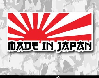 May include: A white sticker with a red rising sun graphic and the text "MADE IN JAPAN" in black.