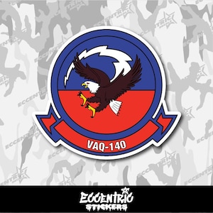 May include: A sticker featuring a stylized eagle with outstretched wings, set against a red and blue background. The design includes the text "VAQ-140" and is surrounded by a blue border. The sticker is from Eccentric Stickers.