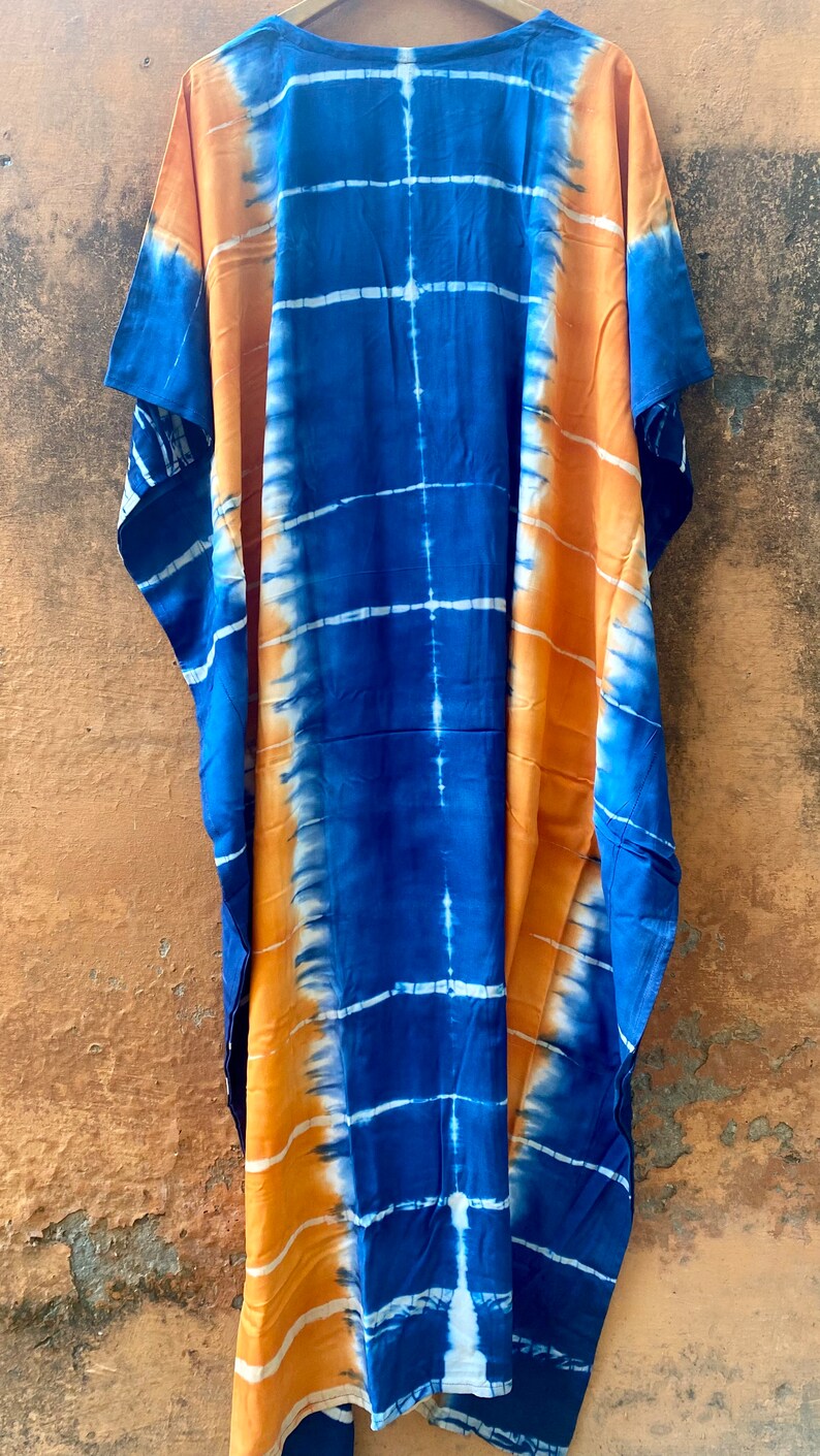 May include: A long, blue and orange tie-dye kaftan with a loose fit and short sleeves.