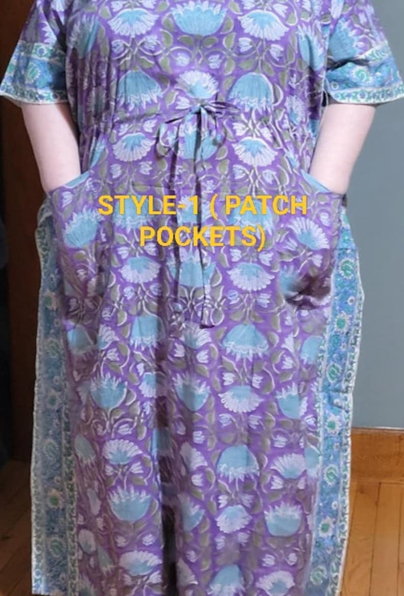 May include: A purple and blue floral print dress with patch pockets. The dress has a tie at the waist and short sleeves. The text "STYLE-1 (PATCH POCKETS)" is visible on the front of the dress.