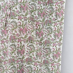 May include: White cotton kaftan with a pink and green floral print. The kaftan has a V-neck and a loose, flowing fit.
