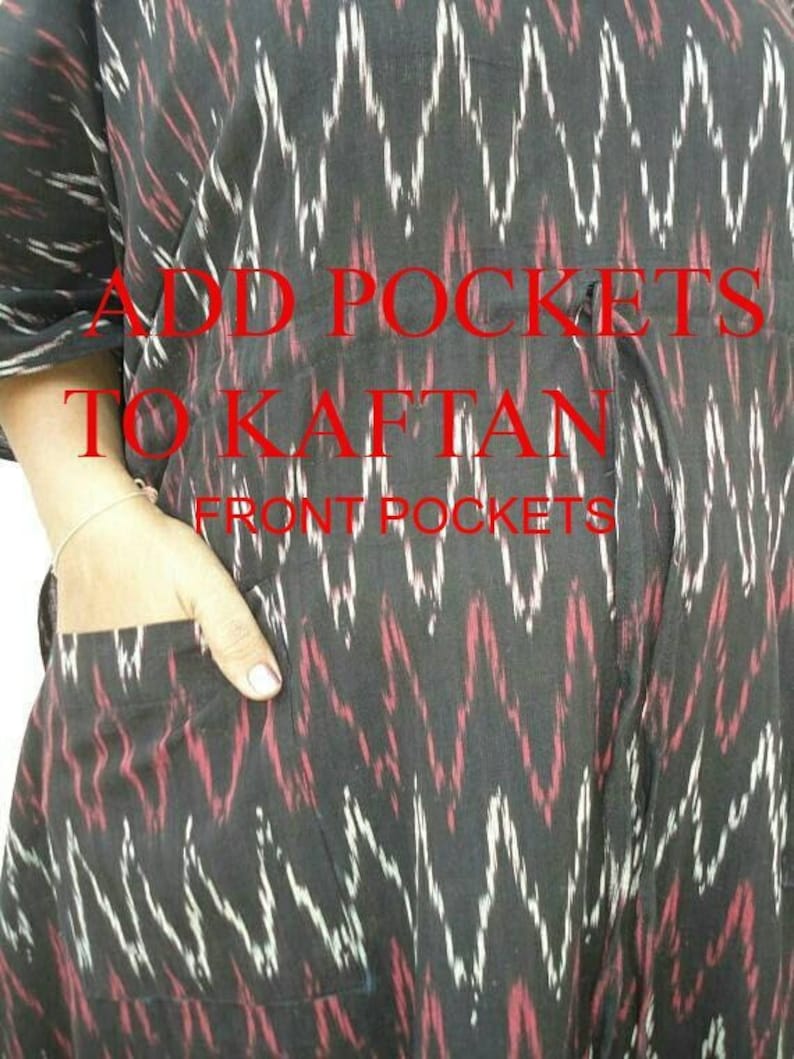 May include: A black kaftan with a red and white zigzag pattern. The kaftan has front pockets and the text "ADD POCKETS TO KAFTAN FRONT POCKETS" in red.