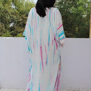 May include: White maxi dress with a tie-dye pattern in shades of pink, blue, and turquoise.