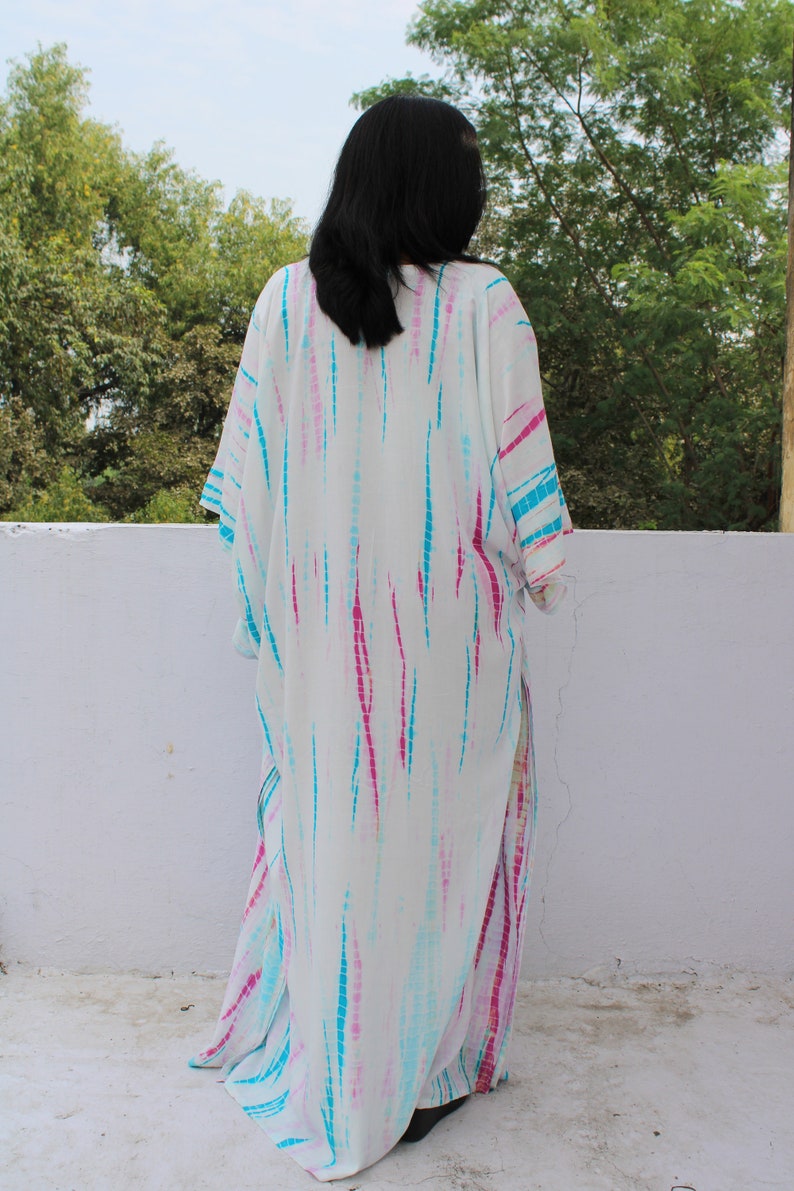 May include: White maxi dress with a tie-dye pattern in shades of pink, blue, and turquoise.