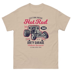 May include: A beige t-shirt with a vintage illustration of a hot rod car. The text "CUSTOM ENGINE Hot Rod 1945" is above the car. Below the car is the text "RETRO REG. TM HOTROD DIRTY GARAGE Authentic Spareparts ESTABLISHED 1945".