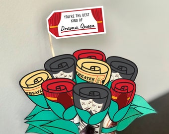May include: A bouquet of red, black, and yellow paper roses with a theater ticket design. The roses are in a clear glass vase with ice and chocolate bars. A red and white sign reads "You're the best kind of Drama Queen".