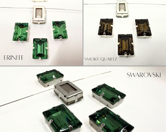 May include: Assortment of emerald green, smoky quartz, and clear crystal rhinestones in rectangular settings. The rhinestones are set in silver-toned metal settings. The text "ERINITE", "SMOKY QUARTZ", and "SWAROVSKI" are visible in the image.
