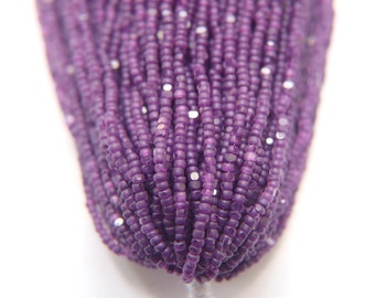 May include: A strand of small, purple glass beads with a slightly iridescent finish.