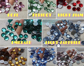 May include: Assortment of Swarovski crystal flatback rhinestones in various colours, including rose, peridot, light Siam, emerald, light sapphire, topaz, sapphire, and light amethyst.