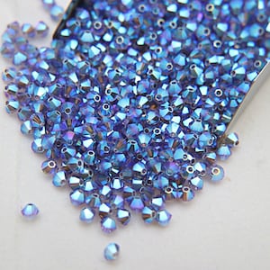 Swarovski (3/4mm) Tanzanite AB 2X FC Bicones Rainbow Beads