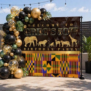 May include: A birthday party backdrop with the text "Welcome to Greg's 50th Birthday Party." The design includes gold animal silhouettes and a colourful patterned section. A balloon arch in gold, black, and green adds to the celebratory atmosphere.