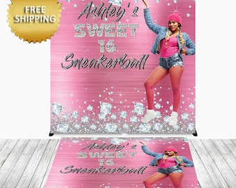 May include: Pink and silver glitter backdrop with the text "Ashley's Sweet 16 Sneakerball" and a woman wearing a denim jacket, pink shirt, and white sneakers.