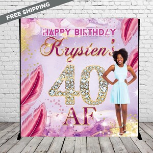 May include: Purple and pink watercolour backdrop with gold glitter accents and pink feathers. The number 40 is made of gold with rhinestones. The text "Happy Birthday Krysten's 40 AF" is in gold and pink lettering.