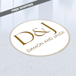 May include: A white circle with a gold double outline and the text "D&J DAMON AND JALISA" in gold lettering.
