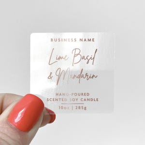 May include: Clear sticker label with the text "BUSINESS NAME", "Lime Basil & Mandarin", "HAND-POURED SCENTED SOY CANDLE", and "10oz | 285g" in rose gold lettering.