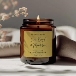 May include: A brown glass candle jar with a gold label that reads "Lime Basil & Mandarin" and "Hand-poured Scented Soy Candle 10oz | 285g".