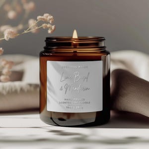 May include: A brown glass candle jar with a white label that reads "BUSINESS NAME Lime Basil & Mandarin HAND-POURED SCENTED SOY CANDLE 10oz | 285g".